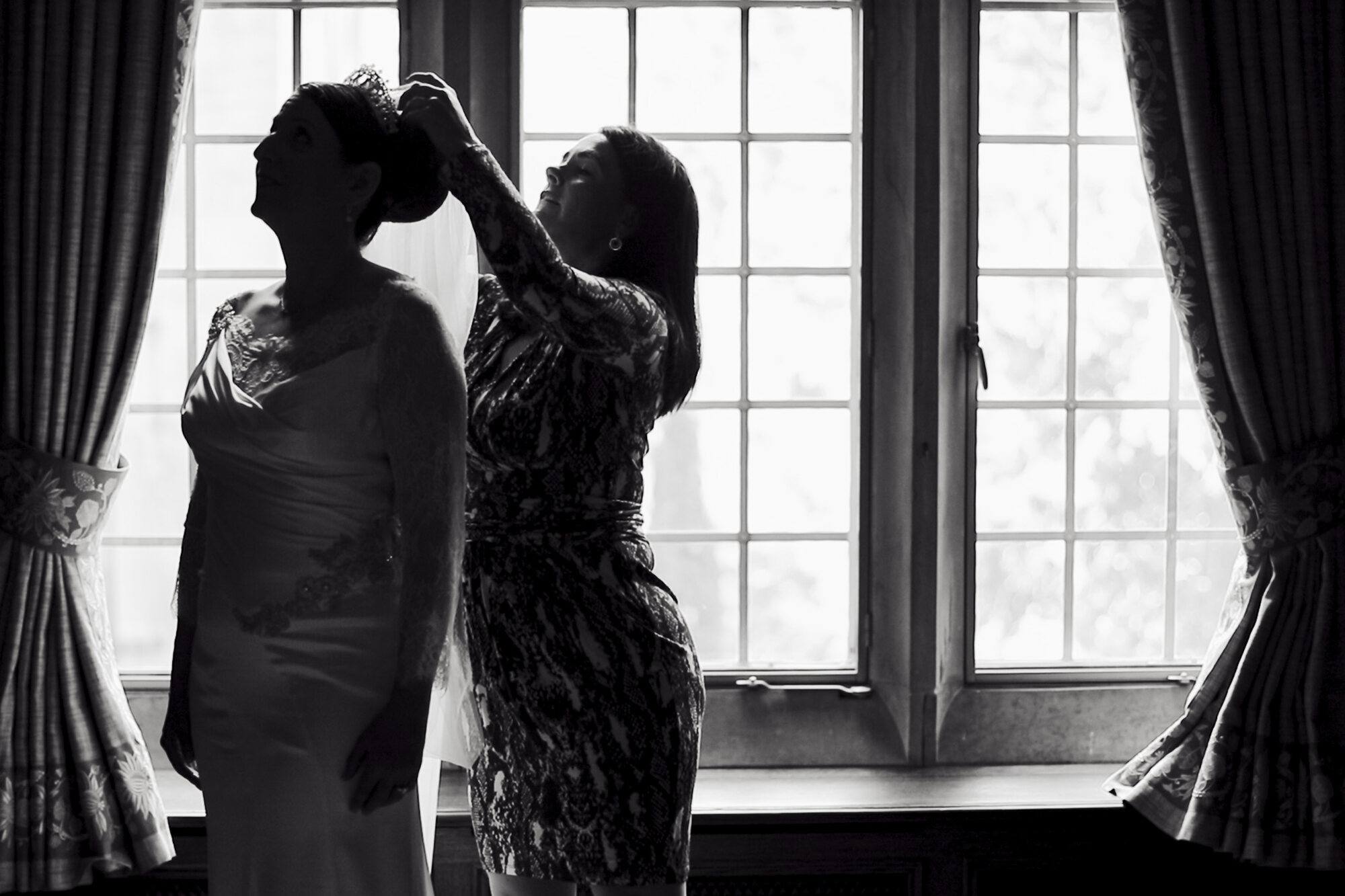 Schwarzweiß: Silhouette der Braut beim Styling am Fenster, Kronberg